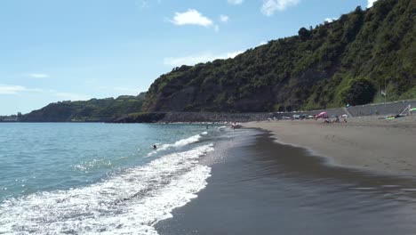 Waves-hitting-the-beach-of-Agua-de-Alto-on-a-sunny-summer-day,-San-Miguel-Island,-Azores,-Portugal---July-2023