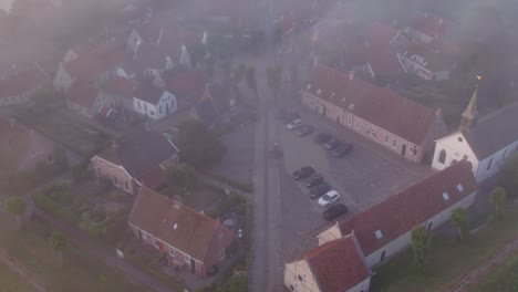 Flying-over-windmill-at-medieval-fortress-Bourtange-Netherlands,-aerial