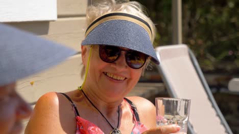 Slow-motion-shot-of-seniors-relaxing-and-drinking-in-the-sun-in-the-south-of-France