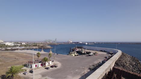Port-of-Sines-in-Portugal,-aerial-forward-on-a-sunny-summer-day,-blue-sky