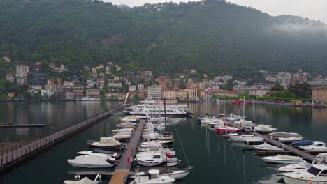 Drone-shot-of-a-boat-harbor-at-Lake-Como,-Italy