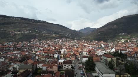 Drone-view-of-the-city-established-in-the-area-extending-towards-the-mountain,-Tetovo-city-of-Macedonia