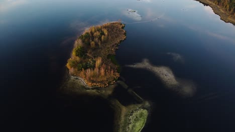 A-drone-rotates-above-a-forested-island-in-Kalmthoutse-Heide-Antwerp,-Belgium
