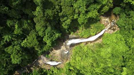Aerial-top-down-shot-of-famous-Huay-Waterfall-in-Thailand-during-sunny-day---orbiting-shot