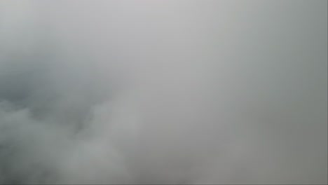 Vista-De-Drones-Volando-A-Través-De-Espesas-Nubes-Sobre-El-Monte-Lovcen,-Montenegro