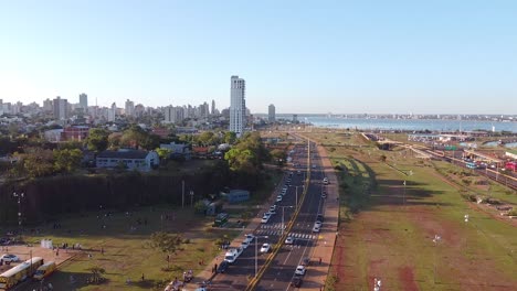 Aerial-view-of-city-skyline,-waterfront,-and-highway-in-Posadas,-Misiones,-Argentina