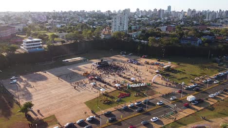 Aerial-view-of-bustling-festival-event-in-the-middle-of-city-landscape-in-Posadas,-Misiones,-Argentina
