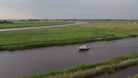 Motorboat-cruising-on-canals-of-alde-feanen-national-park-Friesland,-aerial