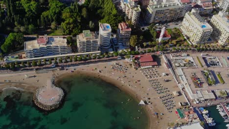 Drone-shot-tilting-up-from-a-small-corner-beach-to-the-town-centre-of-Marbella