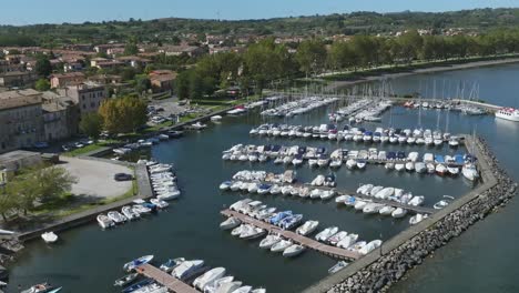 Aerial-over-the-marina-at-Capodimonte-on-Lake-Bolsena,-Province-of-Viterbo,-Italy