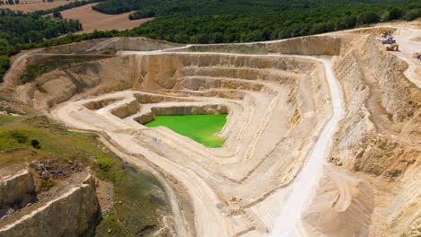 Limestone-Mine-With-A-Quarry-Lake---aerial-drone-shot
