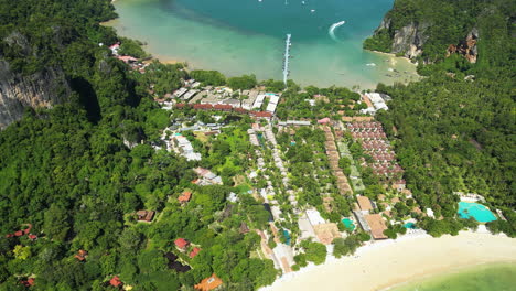 Aerial-tilt-up-revealing-turquoise-sea-of-Railay-beach,-Thailand