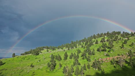 A-rainbow-forming-over-the-hills-of-Boulder,-Colorado,-USA