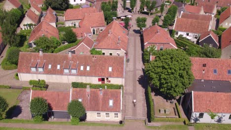 Aerial-shot-of-center-Bourtange-Groningen-with-cycling-people,-aerial