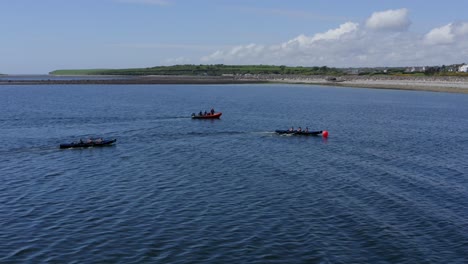 Aerial-descending-orbit-as-currach-rowing-rounds-buoy-in-open-ocean-race