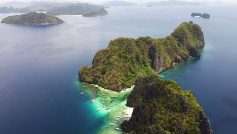 Wide-aerial-point-of-interest-establishing-shot-overlooking-the-beautiful-Palawan-cliffs,-turquoise-ocean-and-islands-in-the-Philippines