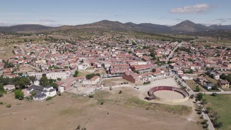 Navas-del-Rey,-Spain,-captivating-drone-view-showcasing-town's-outskirts-and-bullfighting-ring