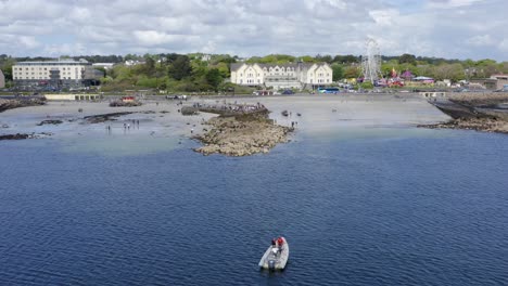 High-angle-wide-view-of-ladies-beach-tidepools-and-tourists-watching-currach-boat-races