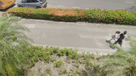 Panning-shot-of-urban-lifestyle-with-people-walking-on-a-sunny-pavement-in-Hong-Kong