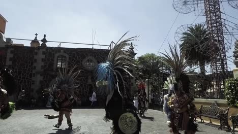 Hand-hed-shot-of-tribal-dancers-performing-on-the-streets-in-front-of-a-large-crowd