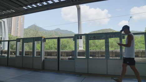 Static-shot-of-people-walking-on-the-train-platform-as-the-transportation-approaches-to-let-people-off