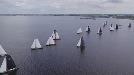 Classic-sail-boat-race-at-Friesland-Netherlands-at-big-lake-Tjeukemeer,-aerial