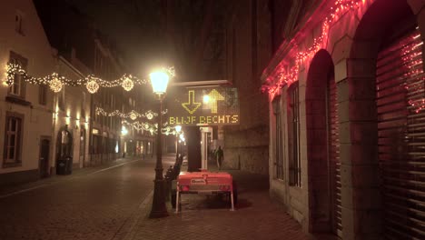 Maastricht-at-night-with-Christmas-lights-and-social-distance-sign