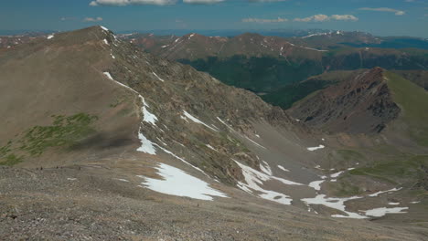 Aerial-cinematic-drone-early-morning-hiking-trail-from-Grays-to-Torreys-14er-Peaks-saddle-Rocky-Mountains-Colorado-stunning-landscape-view-mid-summer-green-beautiful-snow-on-top-forward-movement
