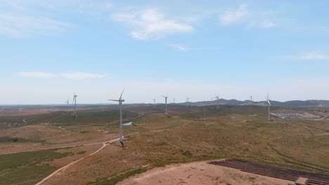 Aerial-dolly-to-wind-farm-turbines-that-are-not-spinning,-renewable-energy-in-desert