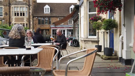 Men-and-women-seated-outside-a-local-cafe-enjoying-a-peaceful-drink-and-chat