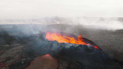 Aerial-view-over-the-volcano-erupting-at-Litli-Hrutur,-Iceland,-with-lava-and-smoke-coming-up