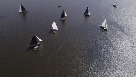 Reveal-shot-of-classic-sailing-boats-on-lake-at-Echternerbrug-Friesland