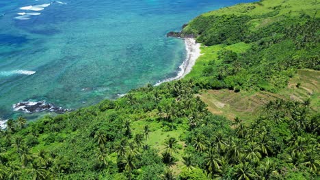 Exotic-sand-beach-in-the-Philippines-rainforest,-aerial-dolly-in,-turquoise-sea