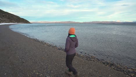 Woman-walking-on-a-snowy-beach-in-Patagonia
