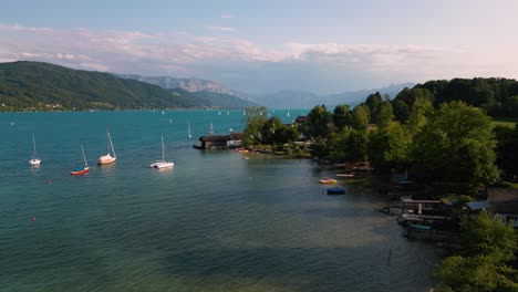 Blue-lake-Attersee-in-Austria-with-clear-water,-alps-mountains,-sailing-ship-boat-near-idyllic-scenic-Wolfgangsee,-Mondsee-close-to-famous-Mozart-city-Salzburg