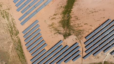 Bird's-eye-view-top-down-perspective-of-solar-panel-farm-in-desert-landscape