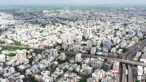 Aerial-camera-is-rotating-showing-the-entire-Rajkot-city,-millions-of-residences-and-commercial-complexes-and-all-the-buildings-are-super-solar-panels