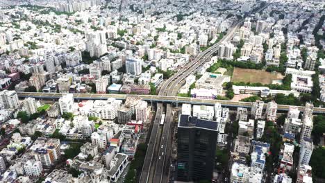 Aerial-drone-camera-moving-towards-the-front-of-Rajkot-city-showing-multiple-fly-over-bridges-and-residential-and-commercial-complexes-on-all-sides