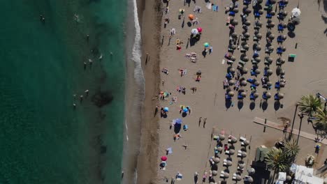 Drone-top-shot-rising-over-a-beach-in-Marbella