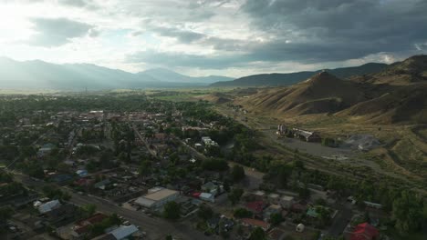 Aerial-cinematic-drone-sunset-afternoon-summer-downtown-Salida-Lime-Mill-Colorado-near-Buena-Vista-Arkansas-River-Riverside-Park-Scout-surfing-wave-biking-hiking-rafting-Rocky-Mountain-backward-motion