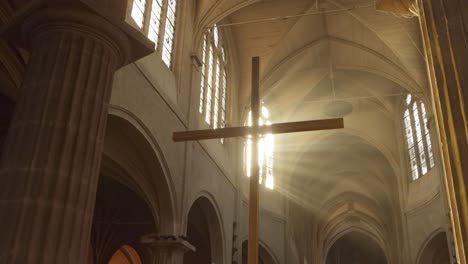 Sunlight-penetrates-basilica-clerestory-church-window.-Wooden-cross