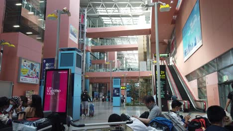 Entrance-Hall-of-Osaka-KIX-Airport-Japan-People-Sit,-Rest,-Kansai-International-Aviation-Port