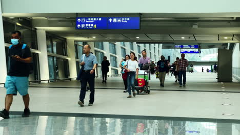 Statische-Aufnahme-Von-Menschen,-Die-Auf-Einem-Geschäftigen-Flughafen-In-Hongkong-Unterwegs-Sind