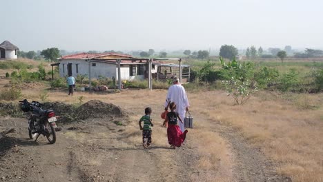 A-saint-is-walking-along-a-village-road-holding-a-musical-instrument-in-both-hands-and-two-small-children-are-following-behind-him