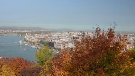 Pan-to-the-left-from-autumn-trees-to-Budapest-from-Buda-Gellért-Hill