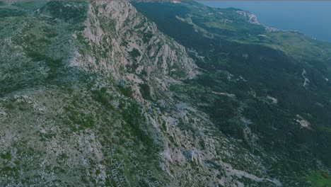Dramatic-steep-mountain-range-biokovo-on-Croatian-coastline,-aerial-tilt-up