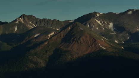 Aerial-cinematic-drone-sunrise-sunlight-early-morning-shadows-Grays-and-Torreys-14er-Peaks-Rocky-Mountains-Colorado-stunning-landscape-view-mid-summer-snow-on-top-zoom-Grizzly-circling-right-movement