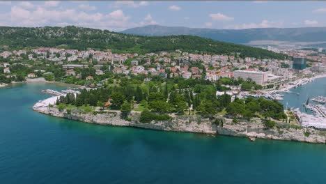 Sustipan-memorial-park-in-Split,-Croatia,-aerial-orbit-city-skyline,-blue-sky