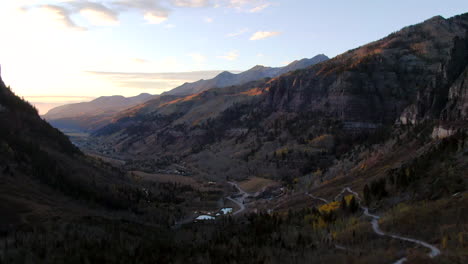 Aerial-cinematic-drone-sunset-sunrise-fall-autumn-beautiful-stunning-Telluride-Colorado-Bridal-Veil-waterfalls-off-road-track-view-of-ski-historic-downtown-orange-yellow-gold-aspen-trees-forward