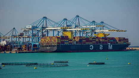 Moving-containers-with-cranes:-a-time-lapse-of-the-port-of-Kalafrana,-Malta